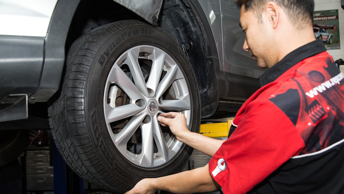 car on hoist for tyre inspection at One Stop Auto Care